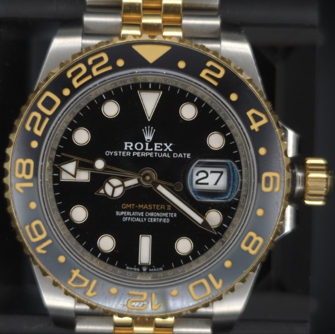 A Rolex GMT-Master II photographed front-on, with the dial, bezel, rehaut and hands marked